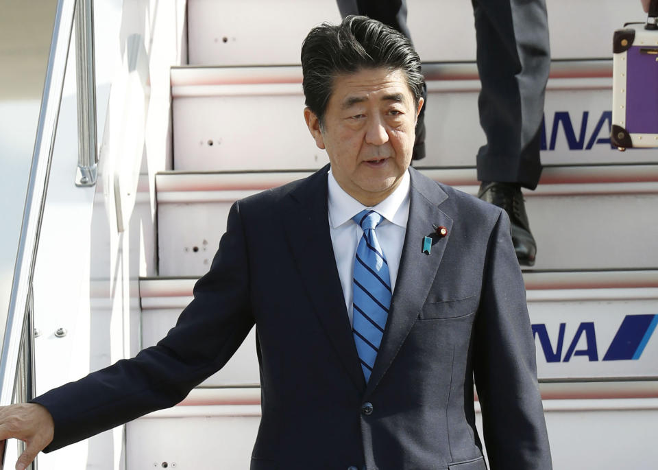 Japanese Prime Minister Shinzo Abe arrives at Haneda airport in Tokyo Friday morning, June 14, 2019 after a two-day visit to Iran. A Japanese-owned oil tanker was attacked near the Strait of Hormuz on Thursday. (Naoya Osato/Kyodo News via AP)