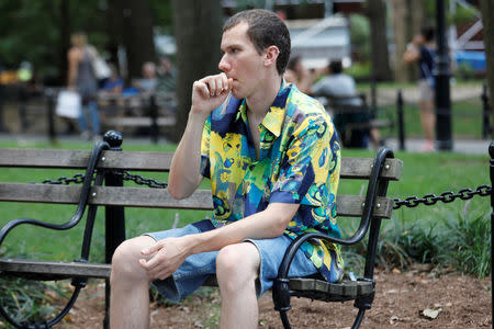 Adam Trubitt, 21, vapes a Juul e-cigarette in Washington Square Park, Manhattan, New York, U.S., August 30, 2018. REUTERS/Shannon Stapleton