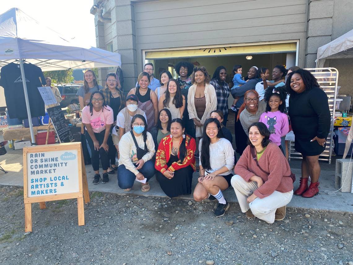 Community members gather for a photo at the “Rain or Shine” community artisan and maker market event on Oct. 2, 2022, at Parable.