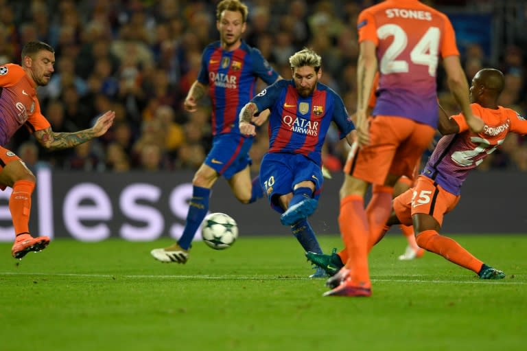 Barcelona's forward Lionel Messi (C) shoots to score a goal during the UEFA Champions League football match FC Barcelona vs Manchester City at the Camp Nou stadium in Barcelona on October 19, 2016