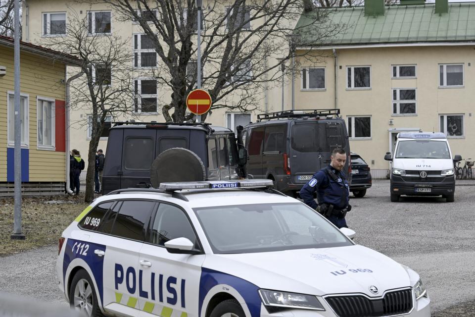 Finnish police officers and police vehicles are seen at the primary Viertola comprehensive school where a child opened fire and injured three other children, on April 2, 2024 in Vantaa, outside the Finnish capital Helsinki. Police said, that the attacker was in custody, and "All those involved in the shooting incident are minors".