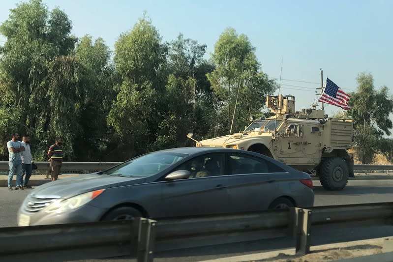 A U.S military vehicle is seen driving on a street in Dohuk