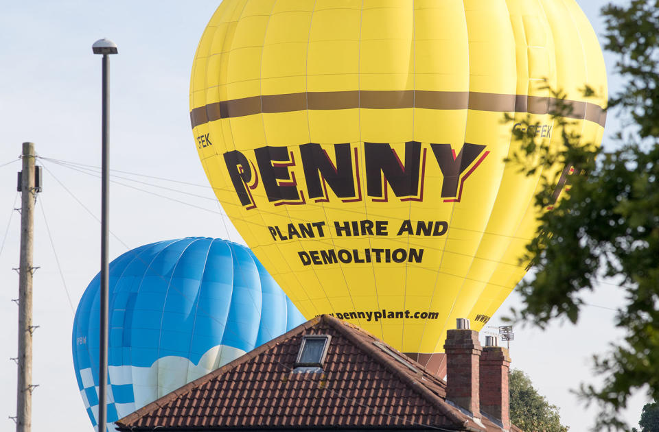 <p>Hot air balloons come into land as they participate in the mass assent at sunrise on the second day of the Bristol International Balloon Fiesta on August 11, 2017 in Bristol, England. (Photo: Matt Cardy/Getty Images) </p>