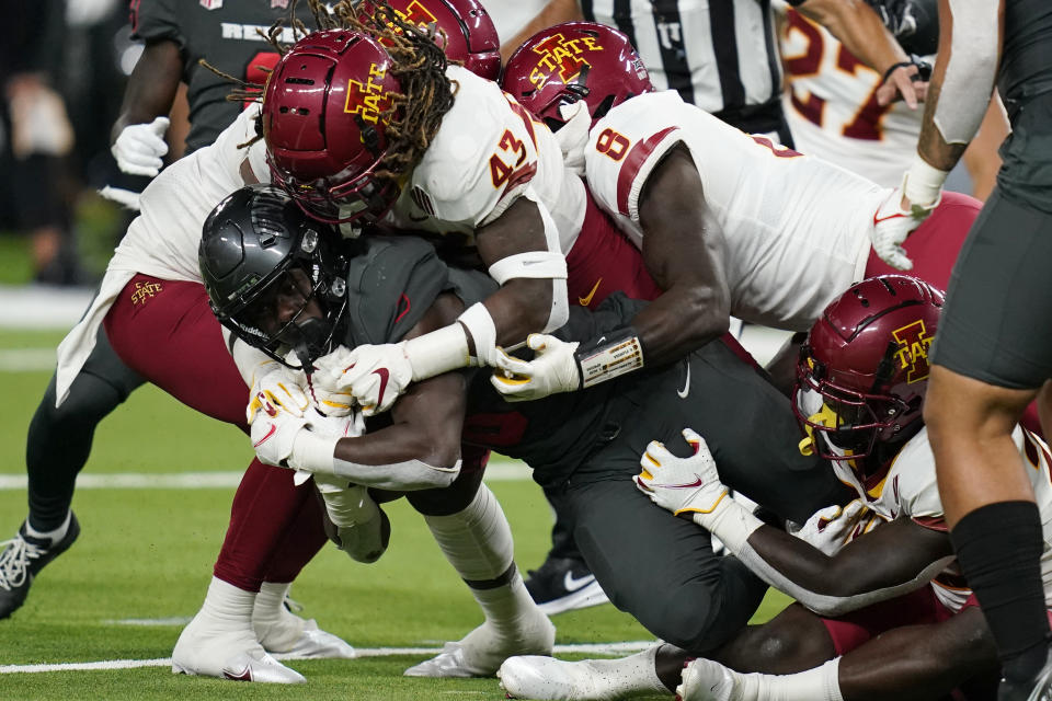 owa State linebacker Dae'Shawn Davis (43) tackles UNLV running back Charles Williams (8) during the second half of an NCAA college football game Saturday, Sept. 18, 2021, in Las Vegas. (AP Photo/John Locher)