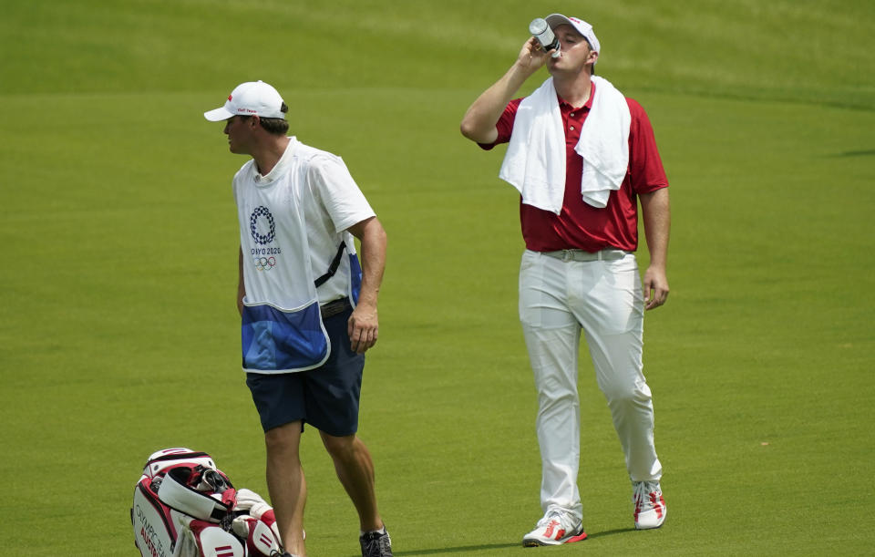 Austria's Sepp Straka refreshes on the 15th green during the first round of the men's golf event at the 2020 Summer Olympics on Wednesday, July 28, 2021, at the Kasumigaseki Country Club in Kawagoe, Japan. (AP Photo/Matt York)