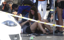 <p>Injured people are treated in Barcelona, Spain, Aug. 17, 2017 after a white van jumped the sidewalk in the historic Las Ramblas district, crashing into a summer crowd of residents and tourists and injuring several people, police said. (Oriol Duran/AP) </p>