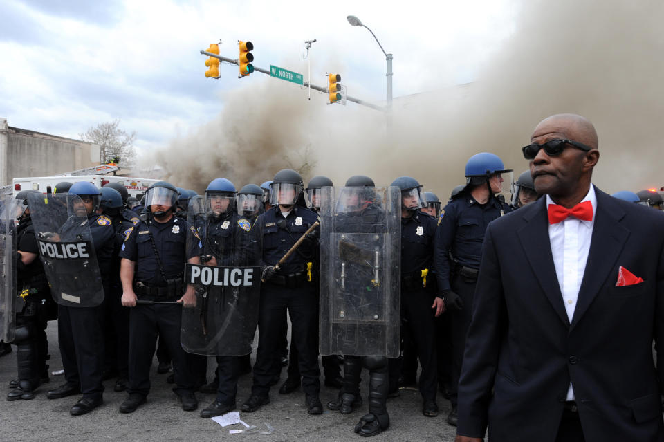 A member of the Nation of Islam stands between protesters and police at North and Pennsylvania Avenues where riots broke out on Monday, April 27, 2015, Baltimore, MD, USA. Photo by Algerina Perna/Baltimore Sun/TNS/ABACAPRESS.COM