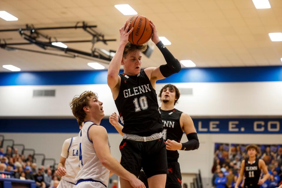 John Glenn's Noah Dreibelbeis (10) grabs the rebound as LaVille's Ryan James (4) defends during the John Glenn-LaVille high school Bi-County championship basketball game on Saturday, January 21, 2023, at LaVille High School in Lakeville, Indiana.