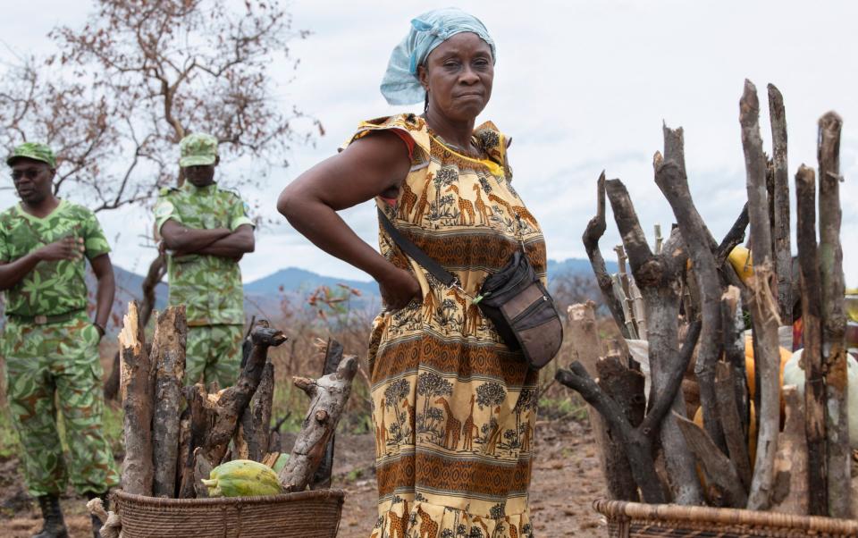 Mamma Georgette, 55, with firewood and her daily harvest in Gabon - David Rose