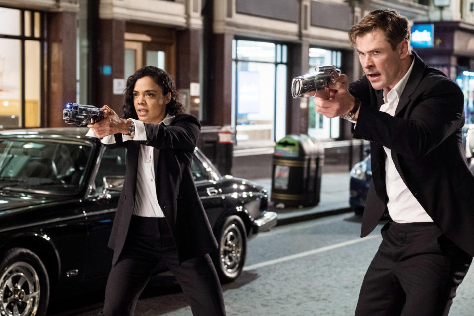 Chris Hemsworth and Tessa Thompson hold up their guns in "Men in Black: International"