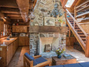 <p>A massive granite stone Rumford Fireplace sits at the heart of the cottage. (Team Haliburton Highlands at RE/MAX) </p>