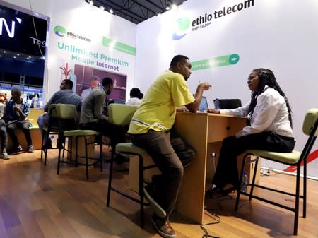 FILE PHOTO: Customers receive assistance from a staff member at an Ethio Telecom branch in Addis Ababa