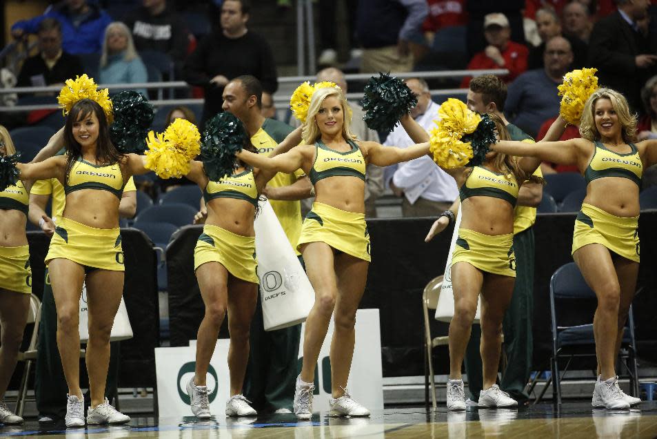 Oregon cheerleaders perform during the first half of a second-round game against the BYU in the NCAA college basketball tournament Thursday, March 20, 2014, in Milwaukee. (AP Photo/Jeffrey Phelps)