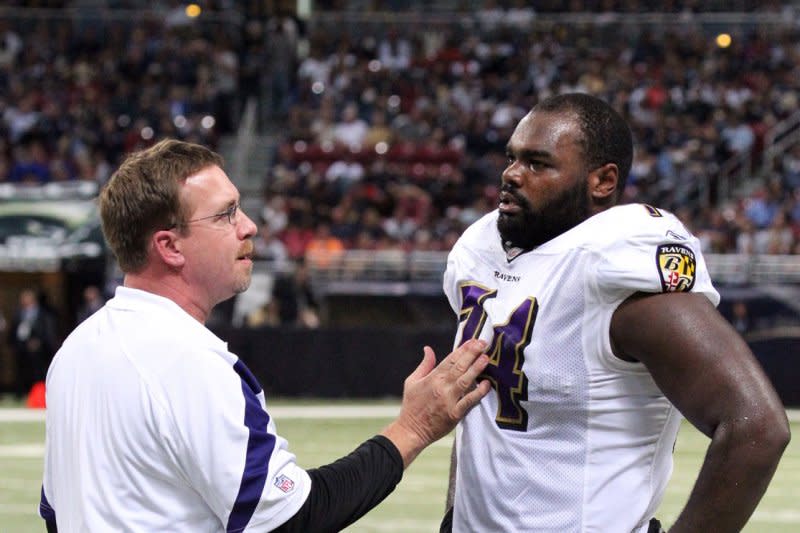 Baltimore Ravens offense line coach Andy Moeller talks with lineman Michael Oher, who was portrayed in the 2009 blockbuster "The Blind Side," at a game in St. Louis in 2011. File Photo by Robert Cornforth/UPI