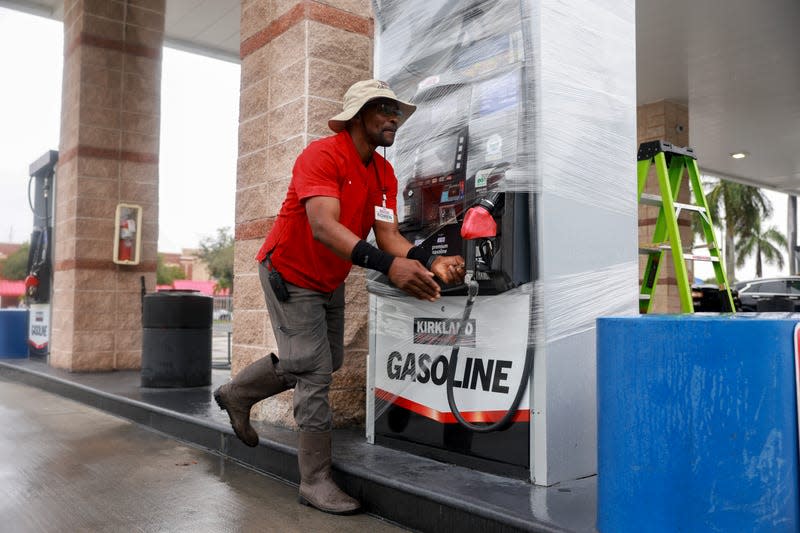 Rown Williamson secures a gas pump at a Costco store before the arrival of Hurricane Milton on October 08, 2024 in Naples, Florida. People are preparing for the storm, which could be a Category 3, when it makes landfall on Wednesday evening. - Photo: Photo by Joe Raedle/Getty Images (Getty Images)