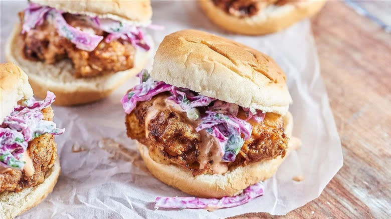 Several yum yum chicken sliders on parchment paper