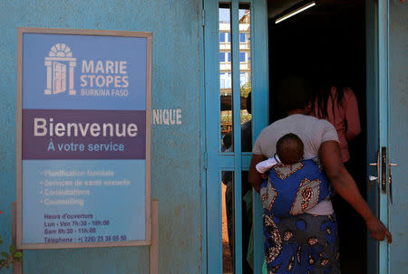 A woman carrying a baby arrives at the clinic of the NGO Marie Stopes in Ouagadougou, Burkina Faso February 16, 2018. REUTERS/Luc Gnago