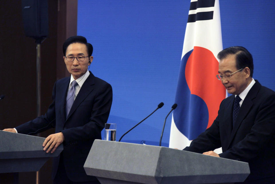 South Korea's President Lee Myung-bak looks on as China's Premier Wen Jiabao speaks during a joint news conference of the fifth trilateral summit among China, South Korea and Japan in Beijing Sunday, May 13, 2012. (AP Photo/Petar Kujundzic, Pool)