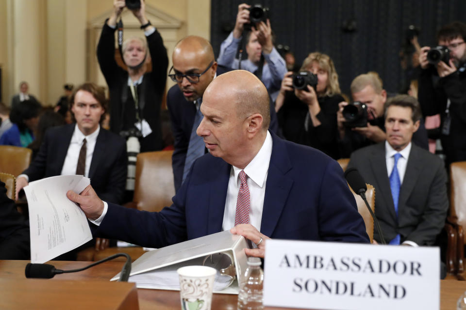 U.S. Ambassador to the European Union Gordon Sondland looks over papers during a break as he testifies before the House Intelligence Committee on Capitol Hill in Washington, Wednesday, Nov. 20, 2019, during a public impeachment hearing of President Donald Trump's efforts to tie U.S. aid for Ukraine to investigations of his political opponents. (AP Photo/Andrew Harnik)