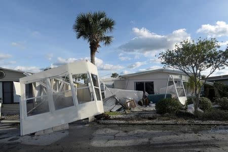 The front of a manufactured home is wrapped around a palm tree in the aftermath of Hurricane Matthew at the Surfside Estates neighborhood in Beverly Beach, Florida, U.S. October 8, 2016. REUTERS/Phelan Ebenhack