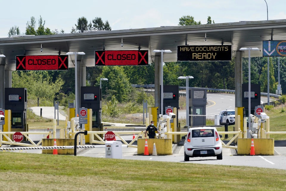 FILE - In this June 8, 2021, file photo, a car approaches one of the few lanes open at the Peace Arch border crossing into the U.S. in Blaine, Wash. Canada is lifting its prohibition Monday, Aug. 9 on Americans crossing the border to shop, vacation or visit, but the United States is keeping similar restrictions in place for Canadians. The reopening is part of a bumpy return to normalcy from COVID-19 travel bans. (AP Photo/Elaine Thompson, File)