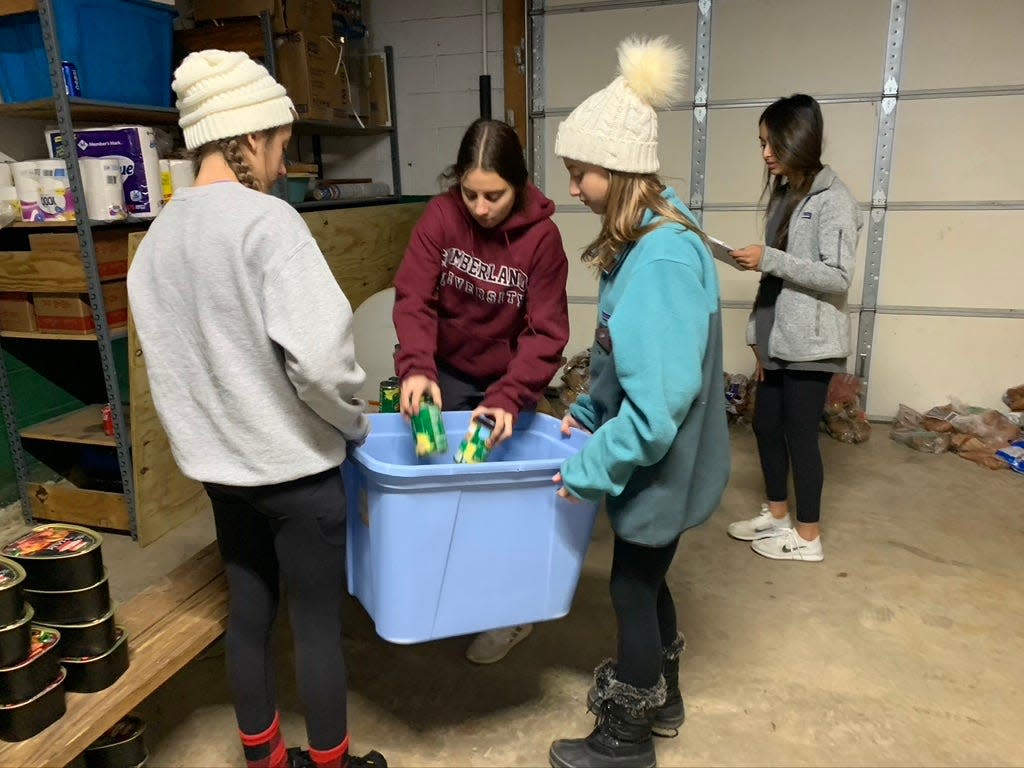 Saint Matthews School students fill bins with Thanksgiving meal supplies in preparation for delivery to Sneedville families.