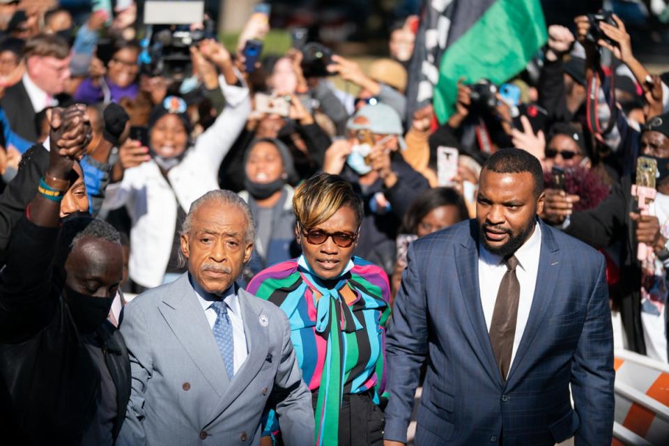 Lee Merritt, Wanda Cooper-Jones and Rev. Al Sharpton (from right to left) outside the courthouse in Georgia after the Black jogger’s three killers were found guilty of murder (Getty Images)