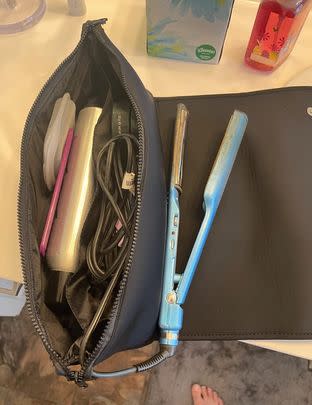 A hybrid hair tools travel bag/heat-resistant mat with lots of space for all your curling and straightening needs, plus a flap closure you can rest them on