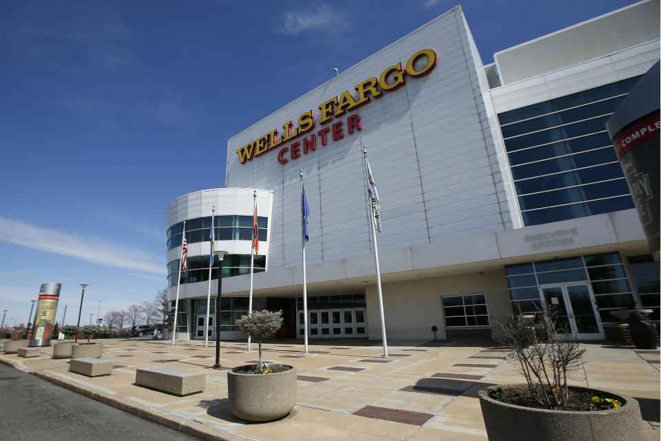 The Wells Fargo Center, home of the Philadelphia Flyers NHL hockey team and the Philadelphia 76ers NBA basketball team, is seen nearly empty, Saturday, March 14, 2020, in Philadelphia. All games at the Center have been postponed due to the COVID-19 pandemic. (AP Photo/Matt Slocum)