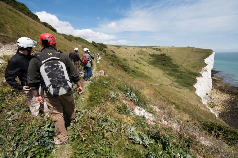 Visitors walk on the cliff-top paths above the Fan Bay Deep Shelter, overlooking Dover, England, on July 23, 2015