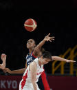 France's Sandrine Gruda (7), left, and Japan's Moeko Nagaoka (0) fight to grab the rebound during women's basketball preliminary round game at the 2020 Summer Olympics, Tuesday, July 27, 2021, in Saitama, Japan. (AP Photo/Charlie Neibergall)