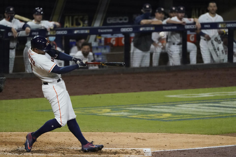 Houston Astros George Springer hits a two run home run against the Tampa Bay Rays during the fifth inning in Game 4 of a baseball American League Championship Series, Wednesday, Oct. 14, 2020, in San Diego. (AP Photo/Ashley Landis)
