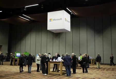 Microsoft Corp shareholders look at Microsoft products before the start of the annual shareholders' meeting in Bellevue, Washington December 3, 2014. REUTERS/Jason Redmond