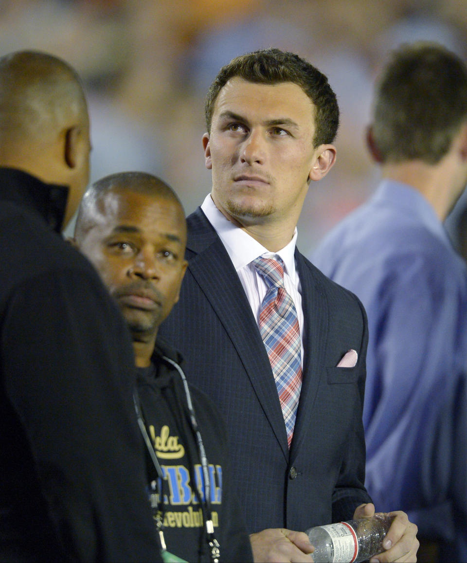 Texas A&M quarterback Johnny Manziel watches from the sidelines during the first half of the NCAA BCS National Championship college football game between Auburn and Florida State Monday, Jan. 6, 2014, in Pasadena, Calif. (AP Photo/Mark J. Terrill)