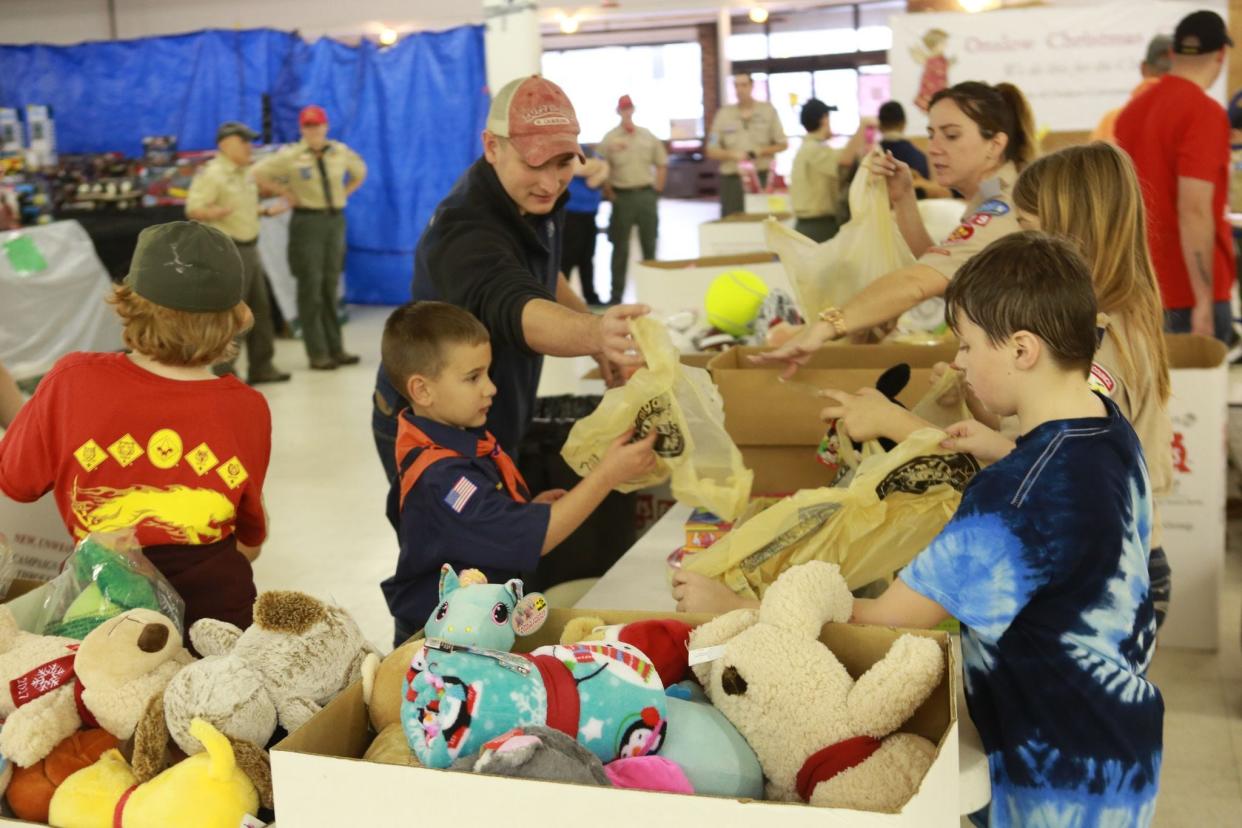 Volunteers sort through toys for Christmas Cheer.