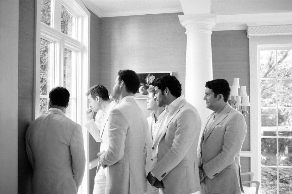 Lee’s groomsmen looking on as guests arrive.