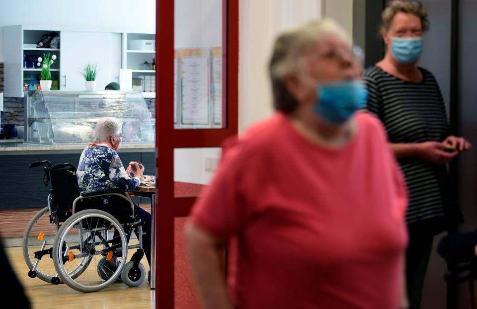 A resident sits at a table in the cafeteria of the retirement home 'CBT-Wohnhaus Zur Heiligen Familie' in Duesseldorf, western Germany on May 13, 2020 amid the ongoing Covid-19, coronavirus pandemic. - North Rhine-Westphalia's Health Minister Karl-Josef Laumann visited a Caritas nursing home in Duesseldorf. On site, he would like to get an idea of how the nursing staff and the home management made the first visits possible after the corona-related visit prohibitions for elderly people. (Photo by Ina FASSBENDER / AFP) (Photo by INA FASSBENDER/AFP via Getty Images)