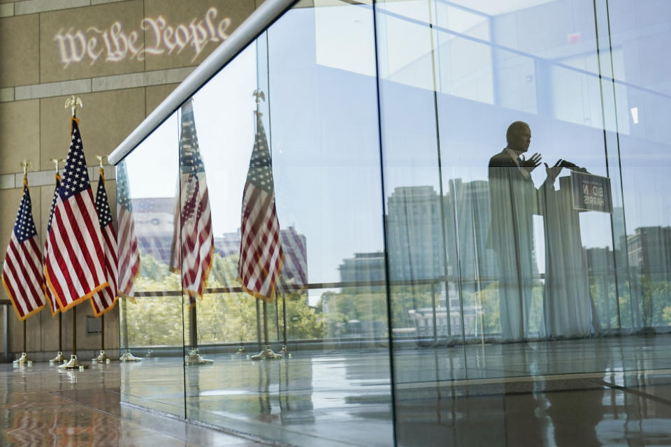 Democratic presidential candidate and former Vice President Joe Biden's reflection is seen from a glass railing while he speaks at the Constitution Center in Philadelphia, Sunday, Sept. 20, 2020, about the Supreme Court. (AP Photo/Carolyn Kaster)
