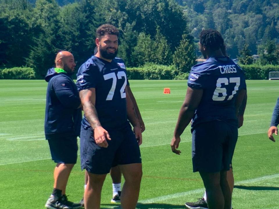 Rookie right tackle Abe Lucas (72) from Washington State walks by rookie left tackle Charles Cross (67) during the start of practice at Seahawks training camp on Aug. 8, 2022, in Renton.