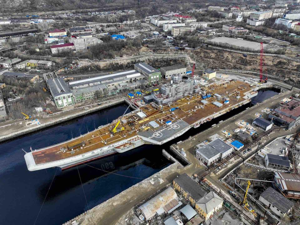 The Russian Navy's lone aircraft carrier, <em>Admiral Kuznetsov</em>, is towed to the 35th squadron shipyard for maintenance and repair works in Murmansk, Russia on May 20, 2022. <em>Photo by Semen Vasileyev/Anadolu Agency via Getty Images</em>