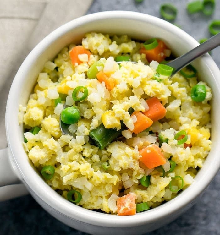 Cauliflower and vegetable fried rice in a mug.