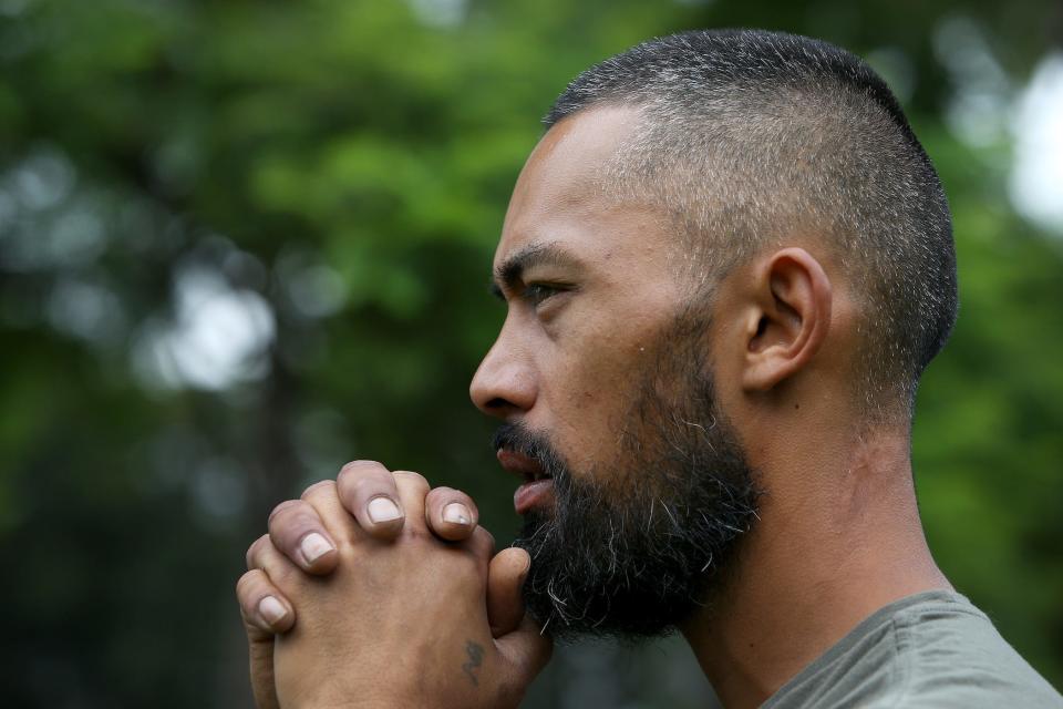 man with focused gaze, hands in prayer, preparing to dance