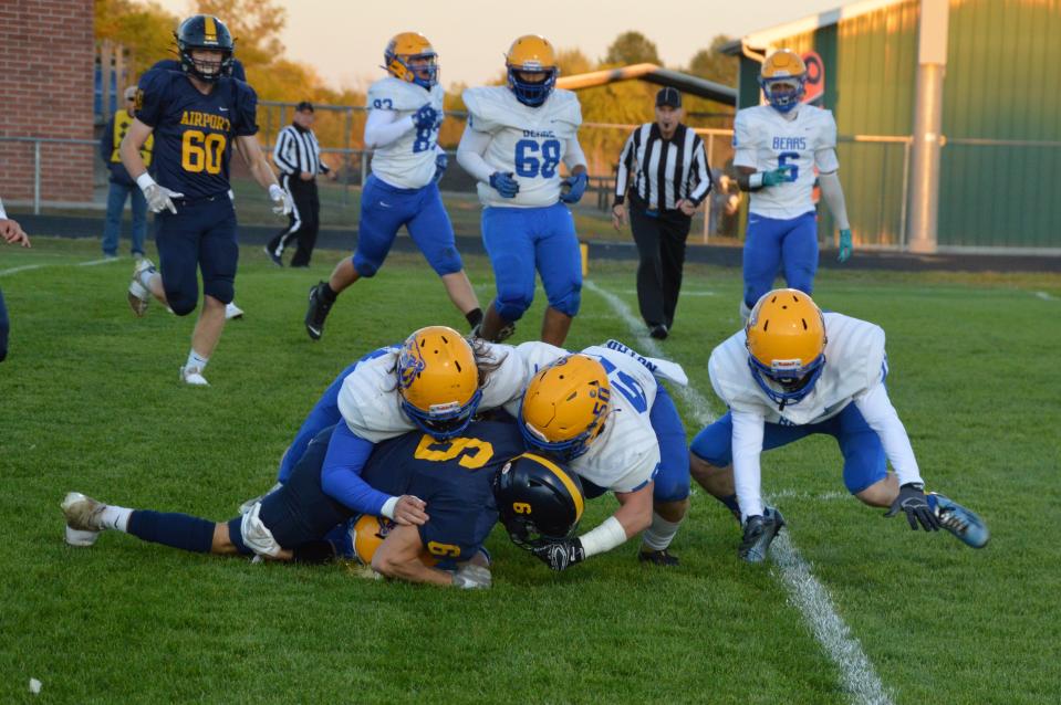 The Jefferson defense wrestles down Colin Nowak of Airport during a 51-14 Airport win Friday night.