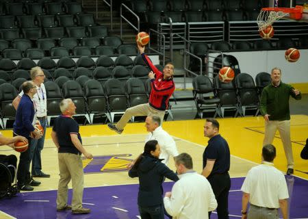 International Olympic Committee Evaluation Commission Chairman Patrick Baumann watches as Los Angeles Mayor Eric Garcetti makes a shot as they tour the Staples Center, home of the Los Angles Lakers, for the LA 2024 bid for the Summer 2024 Olympic Games in Los Angeles, California, U.S., May 11, 2017. REUTERS/Mike Blake