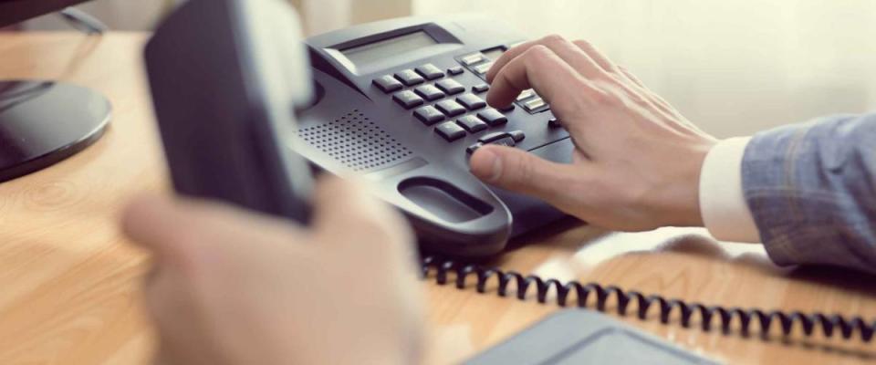 close up of man's hands dialing phone