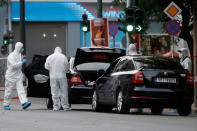 Forensic officers inspect the car of former Greek prime minister and former central bank chief Lucas Papademos following the detonation of an envelope injuring him and his driver, in Athens, Greece, May 25, 2017. REUTERS/Costas Baltas