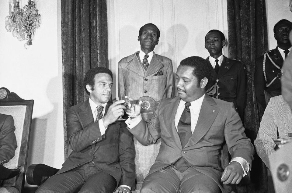 FILE - United Nations Ambassador Andrew Young, left, joins Haiti's President for-life Jean-Claude Duvalier in a toast after their meeting, Monday, August 15, 1977 in Port Au Prince, Haiti. Young came with a list of political prisoners Carter wanted freed and other human rights demands. (AP Photo, File)