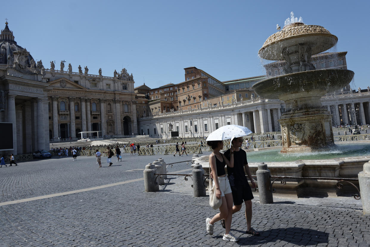 Tourists are filling up water bottles from a public fountain in Saint Peter, Rome. (AP)