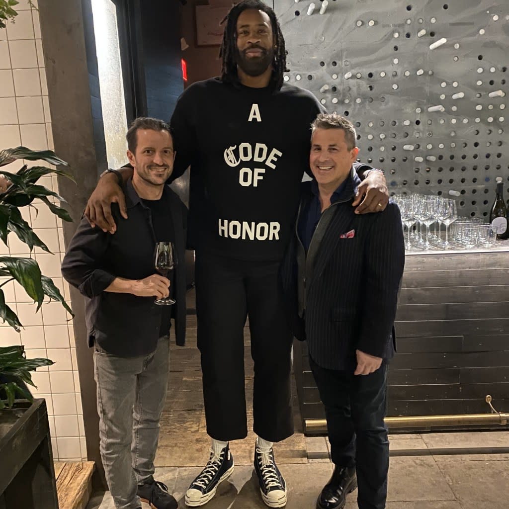 Denver Nuggets player DeAndre Jordan poses with wine club members. @nyvintners/instagram