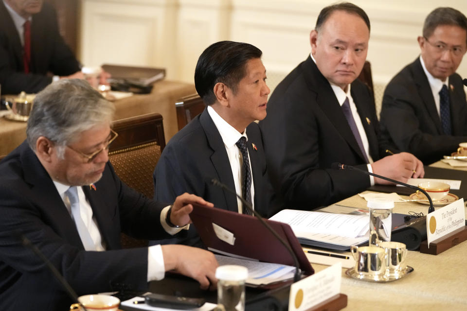 Philippine President Ferdinand Marcos Jr., second left, attends a trilateral meeting with President Joe Biden and Japanese Prime Minister Fumio Kishida, not pictured, in the East Room of the White House in Washington, Thursday, April 11, 2024. (AP Photo/Mark Schiefelbein)